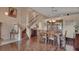 Open-concept dining room showcasing hardwood floors, a staircase, and stylish decor at 261 Clydesdale Cir, Sanford, FL 32773
