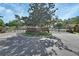 Community entrance with black wrought iron gates, brick pillars, and mature trees at 261 Clydesdale Cir, Sanford, FL 32773
