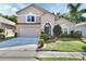 Charming two-story home with a well-manicured lawn, mature landscaping, and a two-car garage at 261 Clydesdale Cir, Sanford, FL 32773