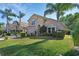 Attractive, two-story home with a lush lawn, mature palms, and a convenient two-car garage at 261 Clydesdale Cir, Sanford, FL 32773