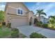 Charming two-story home with a well-manicured lawn, two-car garage, and an arched entryway at 261 Clydesdale Cir, Sanford, FL 32773