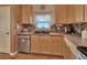Cozy kitchen area with wood cabinetry, stainless appliances, and a stylish backsplash at 261 Clydesdale Cir, Sanford, FL 32773