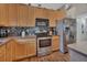 Well-lit kitchen with stainless steel appliances, mosaic tile backsplash, and wood cabinets at 261 Clydesdale Cir, Sanford, FL 32773