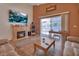 Bright living room featuring a fireplace, large television, and sliding glass doors to a screened patio at 261 Clydesdale Cir, Sanford, FL 32773