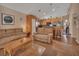 Open-concept living room that flows into the kitchen with tile flooring and neutral-toned sofas at 261 Clydesdale Cir, Sanford, FL 32773