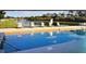 Community pool featuring lounge chairs, lake view and various depth markings for a luxurious experience at 261 Clydesdale Cir, Sanford, FL 32773