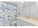 Bathroom featuring a seashell shower curtain, bright vanity, and essential facilities at 2626 S Atlantic Ave # 1080, Daytona Beach, FL 32118