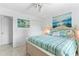 Bedroom with light walls and furnishings, a large window, and beach-themed artwork and decorations at 2626 S Atlantic Ave # 1080, Daytona Beach, FL 32118