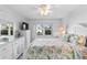 Bright bedroom featuring white furniture and accents, with view to the community pool at 2626 S Atlantic Ave # 1080, Daytona Beach, FL 32118