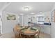 Comfortable dining area with kitchen access and beach themed wall art at 2626 S Atlantic Ave # 1080, Daytona Beach, FL 32118