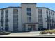 Multi-level condo building showing main entrance and black iron balconies at 2626 S Atlantic Ave # 1080, Daytona Beach, FL 32118