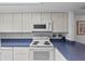 Updated kitchen showcasing white appliances and blue countertops at 2626 S Atlantic Ave # 1080, Daytona Beach, FL 32118