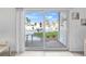 View from inside to the backyard featuring a pool, greenery, and a patio area through sliding glass doors at 2626 S Atlantic Ave # 1080, Daytona Beach, FL 32118