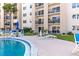 A resort-style condo pool surrounded by tropical landscaping and multiple seating options at 2626 S Atlantic Ave # 1080, Daytona Beach, FL 32118