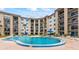Community pool surrounded by lush landscaping and balconies in this inviting condo complex at 2626 S Atlantic Ave # 1080, Daytona Beach, FL 32118