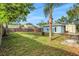 Spacious fenced backyard with lush green grass, storage shed and blue-sided building at 263 Seaview Ave, Daytona Beach, FL 32118