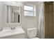 Bright bathroom featuring a clean vanity, toilet, shower with a window, and modern fixtures at 263 Seaview Ave, Daytona Beach, FL 32118
