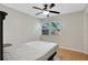 Bedroom with a ceiling fan, window, light colored walls and wood laminate flooring at 263 Seaview Ave, Daytona Beach, FL 32118