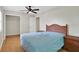 Bedroom with a ceiling fan, closet, wood laminate flooring and a wicker-style bed at 263 Seaview Ave, Daytona Beach, FL 32118