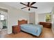 Bedroom with a window, ceiling fan, wood laminate flooring and wicker-style furniture at 263 Seaview Ave, Daytona Beach, FL 32118