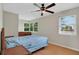 Sunlit bedroom featuring wood laminate flooring, ceiling fan, and multiple windows at 263 Seaview Ave, Daytona Beach, FL 32118
