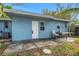 Exterior of the home with blue siding, white door, and an outdoor patio area at 263 Seaview Ave, Daytona Beach, FL 32118