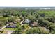 Aerial view of a well maintained residential home with many trees surrounding it near a river at 2635 Wood Duck Vlg, Deland, FL 32720