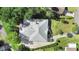 An aerial view of a gray roof home, with a well maintained front yard, and a long driveway at 2635 Wood Duck Vlg, Deland, FL 32720