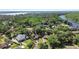 Aerial view of a well-maintained community with lush greenery, waterfront access, and homes with well-kept lawns at 2635 Wood Duck Vlg, Deland, FL 32720