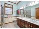 Bathroom with dual vanities, stained glass window, and a framed mirror at 2635 Wood Duck Vlg, Deland, FL 32720