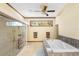 Bright bathroom features a glass shower, soaking tub, and neutral color palette at 2635 Wood Duck Vlg, Deland, FL 32720