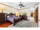 Bedroom features hardwood flooring, decorative trim, and a ceiling fan at 2635 Wood Duck Vlg, Deland, FL 32720