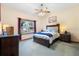 Cozy bedroom with ceiling fan, matching nightstands and closet, bathed in natural light at 2635 Wood Duck Vlg, Deland, FL 32720