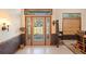 Elegant foyer with tile flooring, decorative glass doors, and stylish decor, creating a welcoming entrance at 2635 Wood Duck Vlg, Deland, FL 32720
