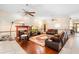 Spacious living room features a fireplace, ceiling fans and comfortable leather furniture at 2635 Wood Duck Vlg, Deland, FL 32720