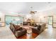 Cozy living room with leather furniture, a fireplace, and access to a screened porch, perfect for relaxation and gatherings at 2635 Wood Duck Vlg, Deland, FL 32720