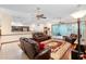 Open living room boasts an area rug, ceiling fans and comfortable leather furniture at 2635 Wood Duck Vlg, Deland, FL 32720