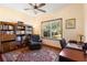 Comfortable office space with built-in bookshelves and natural light from the window at 2635 Wood Duck Vlg, Deland, FL 32720