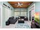 Cozy sunroom featuring tile flooring, wood ceilings, comfortable seating, and large windows, creating a tranquil retreat at 2635 Wood Duck Vlg, Deland, FL 32720