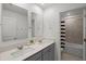 Stylish bathroom with double sinks, quartz counters, and shower and tub combo at 2743 Gentle Rain Dr, Davenport, FL 33837