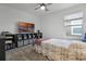 Comfortable bedroom featuring a ceiling fan and entertainment center with TV at 2743 Gentle Rain Dr, Davenport, FL 33837