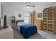 Bright bedroom with a ceiling fan and organized shelving for displaying collectibles at 2743 Gentle Rain Dr, Davenport, FL 33837