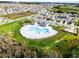 Aerial view of the neighborhood pool and clubhouse nestled amongst single-Gathering homes at 2743 Gentle Rain Dr, Davenport, FL 33837