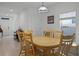 Bright dining room featuring a wood table set, neutral walls, bright light fixture, and access to other living spaces at 2743 Gentle Rain Dr, Davenport, FL 33837