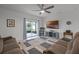 Inviting living room featuring neutral-toned walls, plush seating, a ceiling fan, and sliding glass doors to the outdoors at 2743 Gentle Rain Dr, Davenport, FL 33837