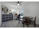 Cozy room with round wooden table, desk, shelving, and gray carpeting at 2743 Gentle Rain Dr, Davenport, FL 33837