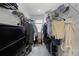 Functional walk-in closet with ample storage shelves, rods, and dresser at 2743 Gentle Rain Dr, Davenport, FL 33837