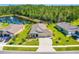 A high angle aerial showcasing the property's manicured lawn and proximity to the pond at 2901 Monaghan Dr, Ormond Beach, FL 32174