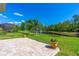 Paver patio and landscaped backyard with a scenic view of the pond with fountain at 2901 Monaghan Dr, Ormond Beach, FL 32174