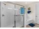 Bright bathroom with a glass-enclosed shower, soaking tub, and a decorative stained-glass window at 2901 Monaghan Dr, Ormond Beach, FL 32174